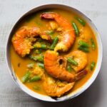 Succulent shrimp are cooked in aromatic coconut milk broth and green beans.
