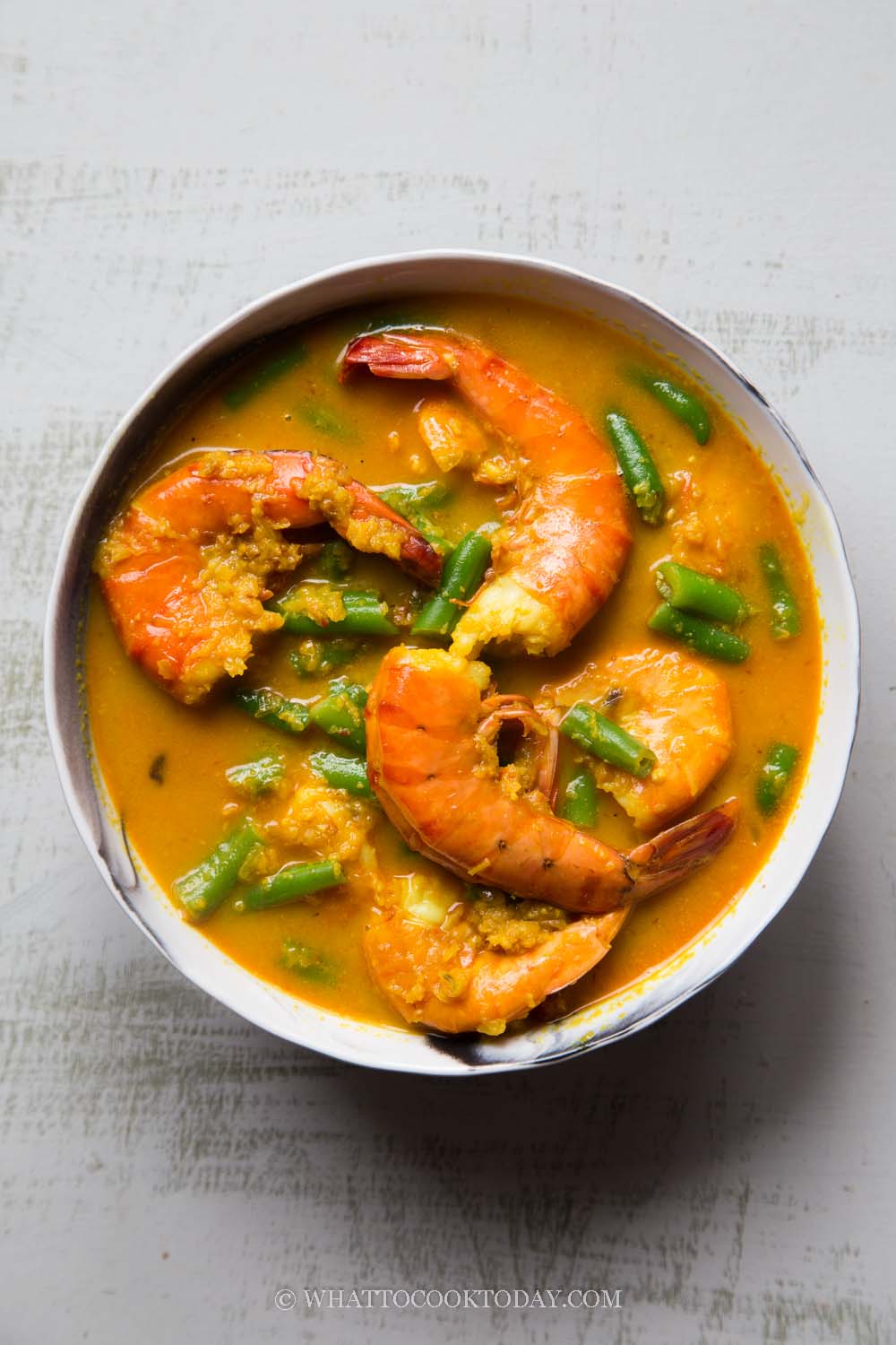 Succulent shrimp are cooked in aromatic coconut milk broth and green beans.