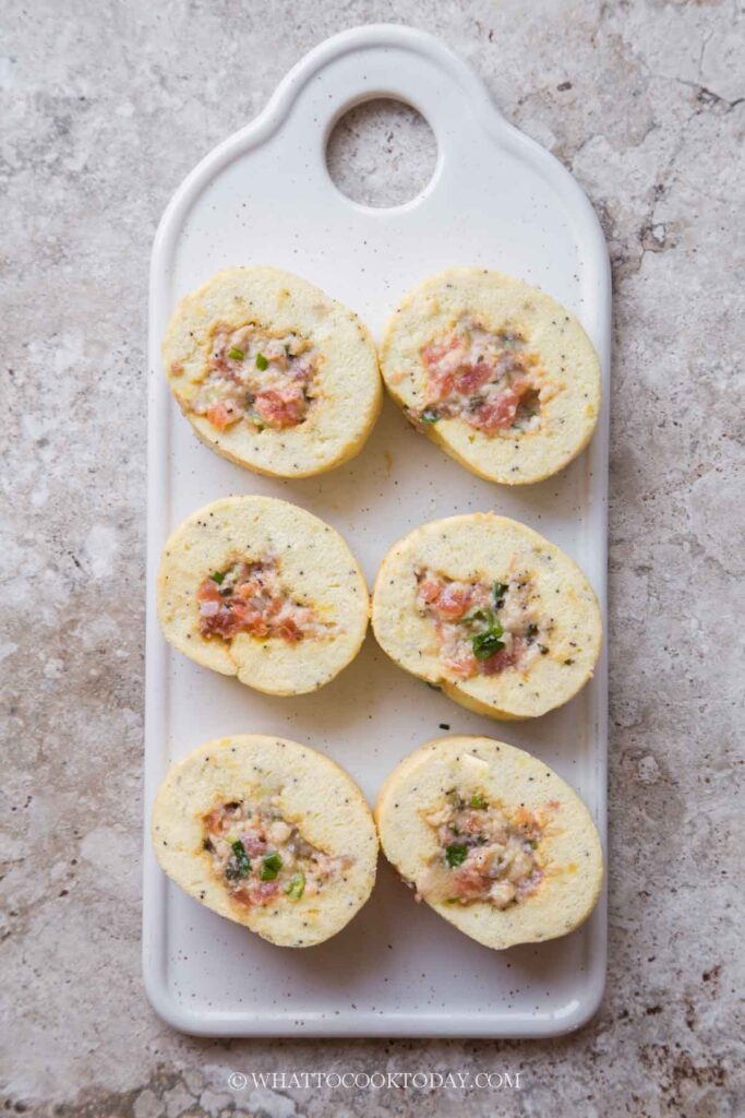 Use the same parchment paper to roll the cake back up tightly. Make sure the seam is at the bottom. Twist the two ends of parchment paper again and keep it chilled in the fridge if not serving right away